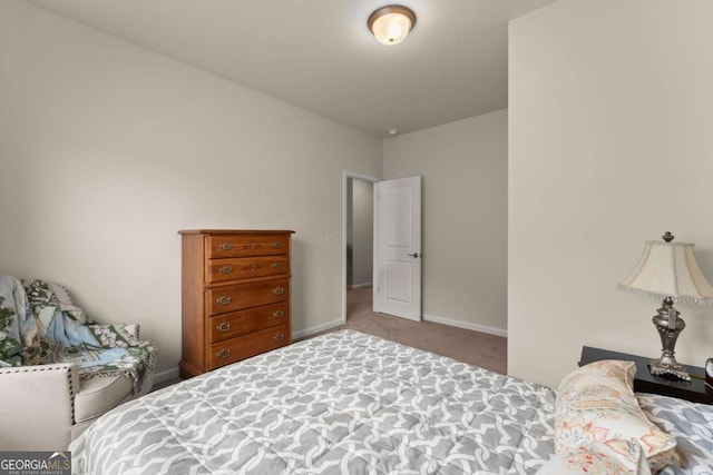 bedroom featuring baseboards and carpet