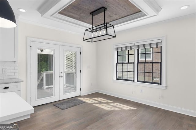 unfurnished dining area with crown molding, baseboards, dark wood-style floors, and french doors
