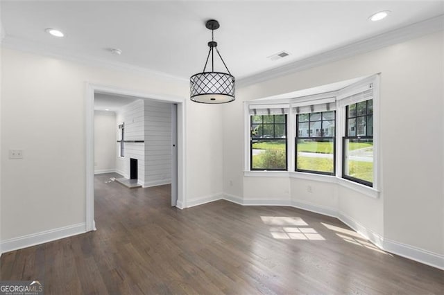 unfurnished dining area featuring crown molding, baseboards, dark wood-type flooring, and visible vents