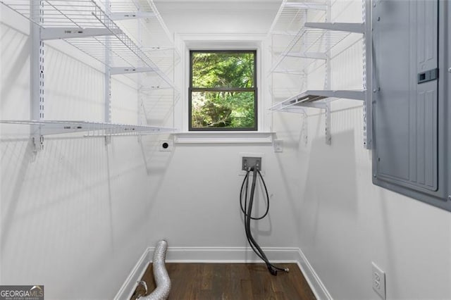 washroom featuring laundry area, washer hookup, baseboards, wood finished floors, and electric panel