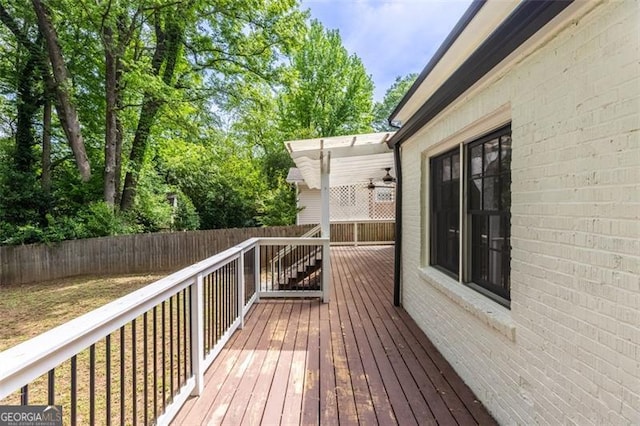 wooden terrace with a fenced backyard