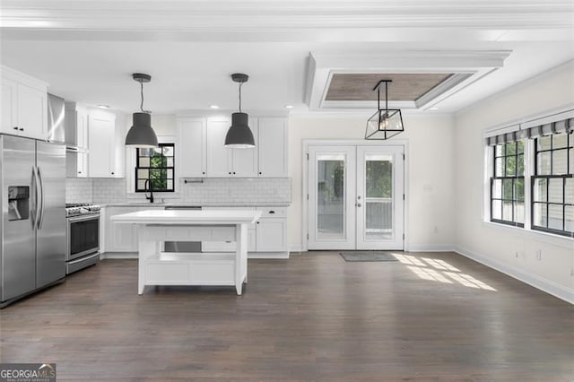 kitchen with light countertops, stainless steel appliances, white cabinetry, and a healthy amount of sunlight