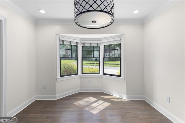 unfurnished room with baseboards, ornamental molding, and wood finished floors