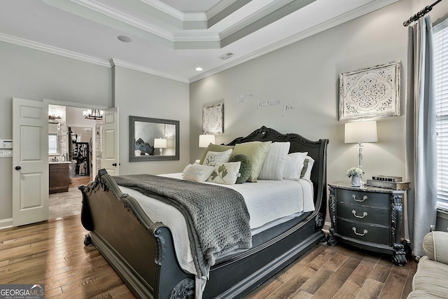 bedroom featuring a raised ceiling, a chandelier, dark wood-style floors, and multiple windows