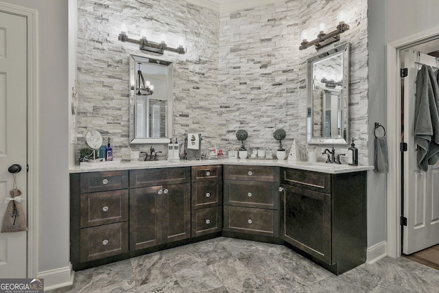 bathroom with an inviting chandelier, double vanity, and a sink