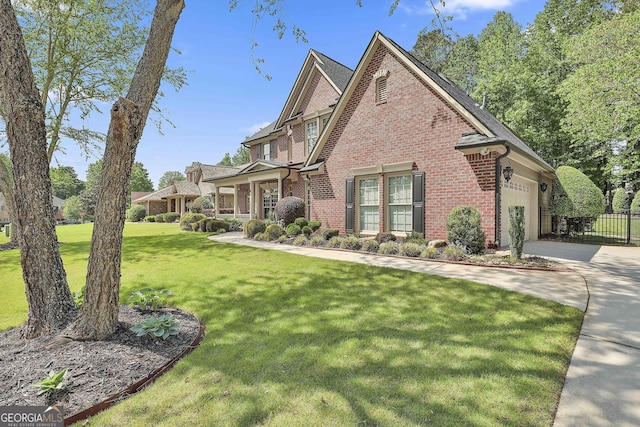 view of side of home featuring fence, brick siding, concrete driveway, an attached garage, and a yard