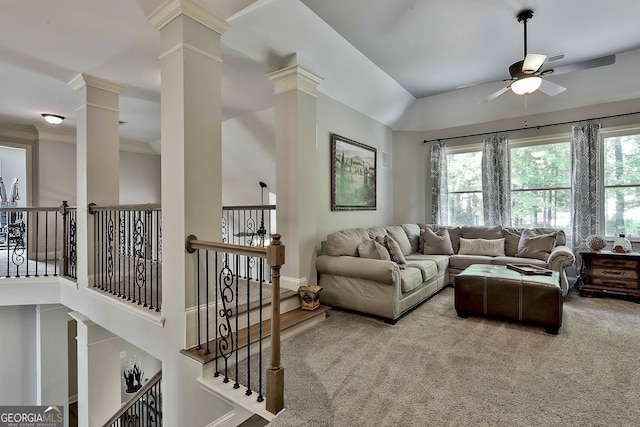 carpeted living area with crown molding, baseboards, a ceiling fan, and ornate columns