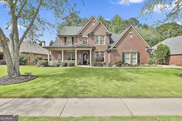 craftsman-style house with covered porch, brick siding, and a front lawn