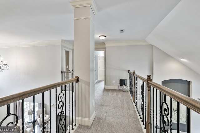 hallway featuring baseboards, carpet flooring, visible vents, and an upstairs landing