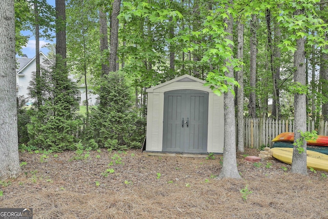view of shed with fence