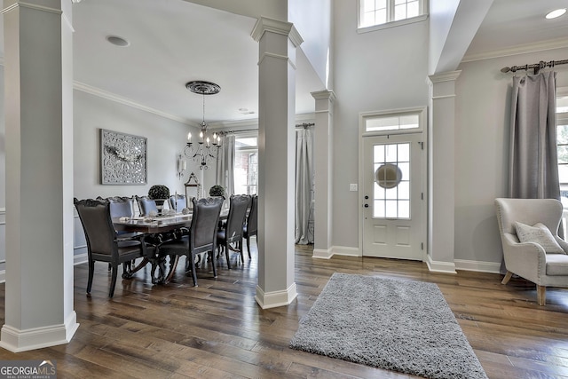 entrance foyer with dark wood-style flooring, baseboards, decorative columns, and ornamental molding