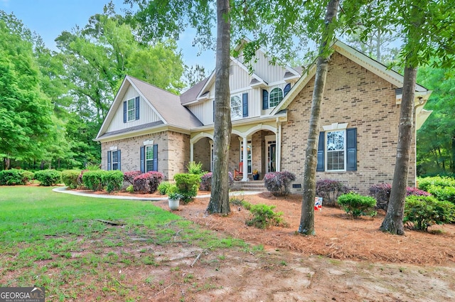 229 Old Plantation Trl NW, Milledgeville, GA 31061 - craftsman-style house featuring covered porch, board and batten siding, a front yard, and brick siding