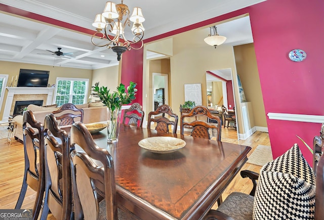 229 Old Plantation Trl NW, Milledgeville, GA 31061 - dining area featuring a fireplace, beamed ceiling, baseboards, light wood-type flooring, and ceiling fan with notable chandelier