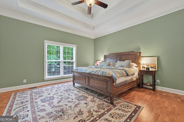 229 Old Plantation Trl NW, Milledgeville, GA 31061 - bedroom with crown molding, a raised ceiling, wood finished floors, and visible vents