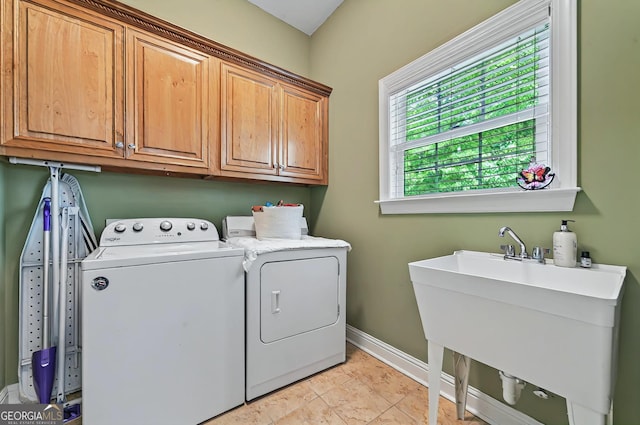 229 Old Plantation Trl NW, Milledgeville, GA 31061 - washroom with baseboards, a sink, cabinet space, and washing machine and dryer