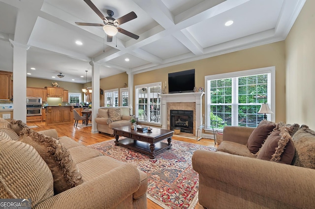 229 Old Plantation Trl NW, Milledgeville, GA 31061 - living area with beamed ceiling, ceiling fan, a tiled fireplace, coffered ceiling, and light wood finished floors