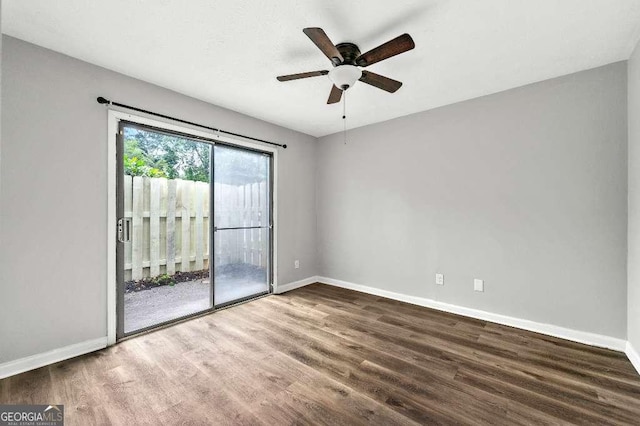 spare room featuring baseboards, a ceiling fan, and wood finished floors