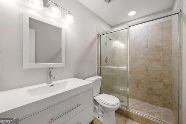 full bath with vanity, tile patterned flooring, a shower stall, and toilet