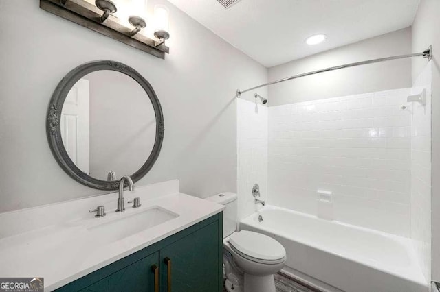 bathroom featuring toilet, washtub / shower combination, and vanity