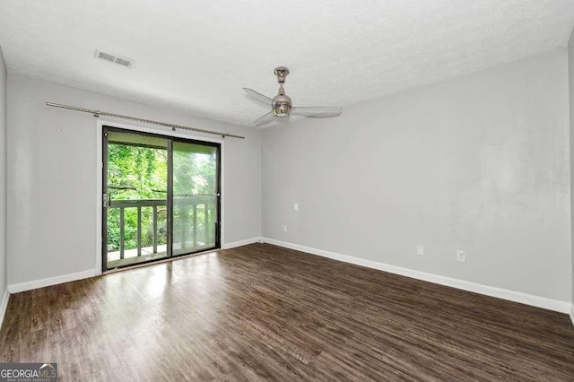 empty room featuring baseboards, ceiling fan, wood finished floors, and visible vents