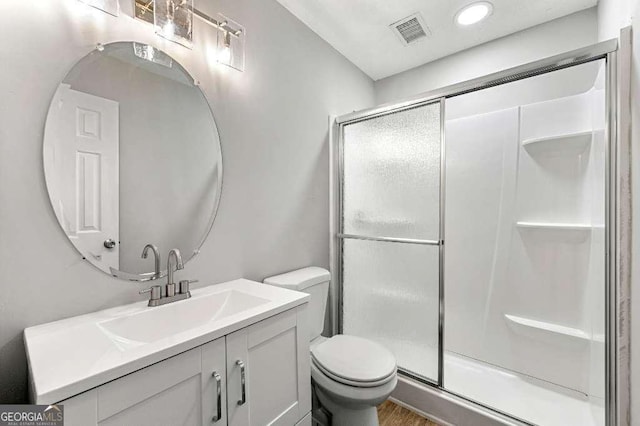 bathroom featuring visible vents, a stall shower, vanity, toilet, and recessed lighting