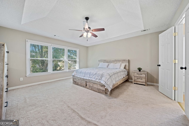 carpeted bedroom featuring a textured ceiling, baseboards, and a ceiling fan