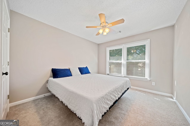 carpeted bedroom with baseboards, a textured ceiling, and ceiling fan
