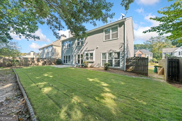 rear view of property with a patio area and a chimney