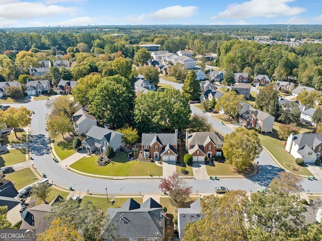 aerial view of property and surrounding area featuring nearby suburban area
