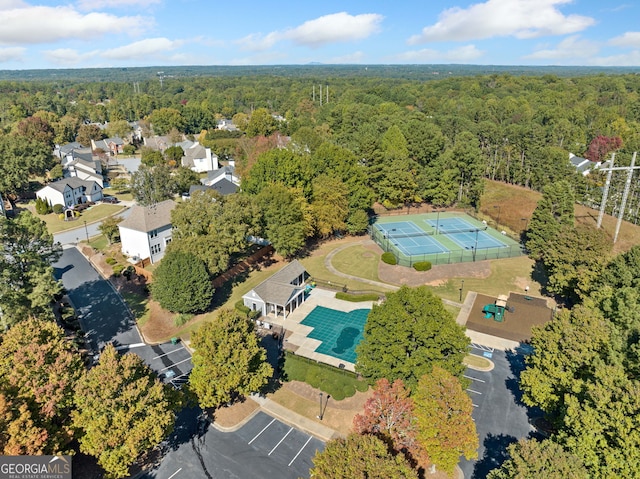 view of property location with a forest