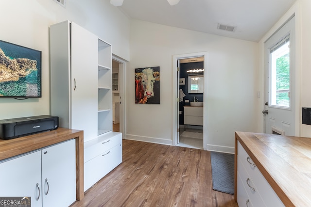 office with lofted ceiling, wood finished floors, and baseboards