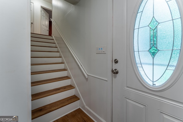 entryway featuring stairs and dark wood-style floors
