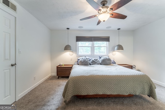 bedroom featuring light colored carpet, baseboards, and ceiling fan