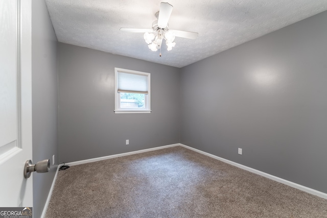 spare room with carpet flooring, ceiling fan, baseboards, and a textured ceiling
