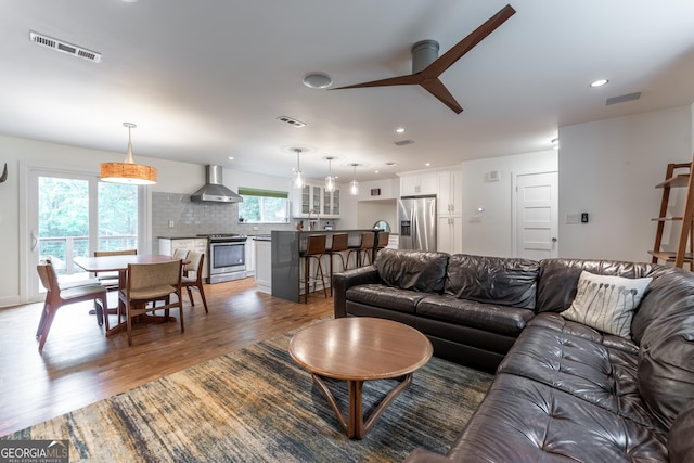 living room featuring wood finished floors, recessed lighting, and ceiling fan
