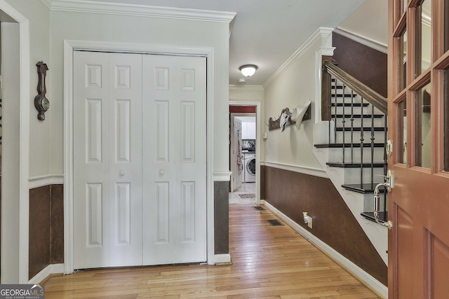 159 May Ln, Zebulon, GA 30295 - foyer entrance featuring crown molding, visible vents, stairs, washer / clothes dryer, and light wood-style flooring