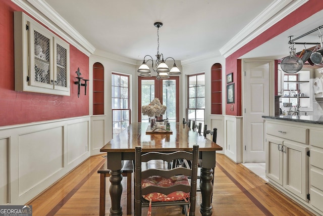 159 May Ln, Zebulon, GA 30295 - dining room featuring an inviting chandelier, crown molding, a decorative wall, and light wood-type flooring