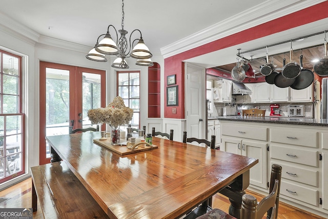 159 May Ln, Zebulon, GA 30295 - dining area with light wood-style floors, ornamental molding, french doors, and a chandelier