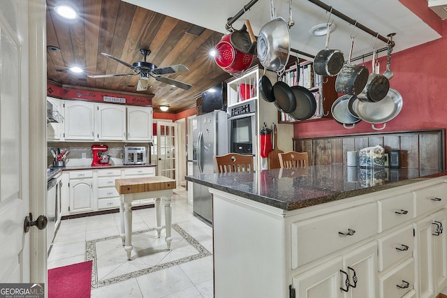 159 May Ln, Zebulon, GA 30295 - kitchen with white cabinets, stainless steel appliances, a ceiling fan, light tile patterned floors, and wood ceiling