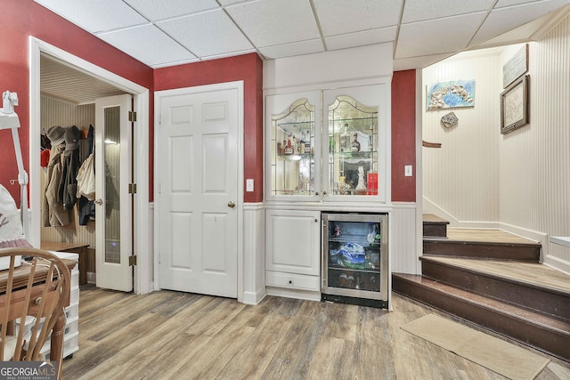 159 May Ln, Zebulon, GA 30295 - interior space featuring a paneled ceiling, a bar, light wood finished floors, beverage cooler, and stairs