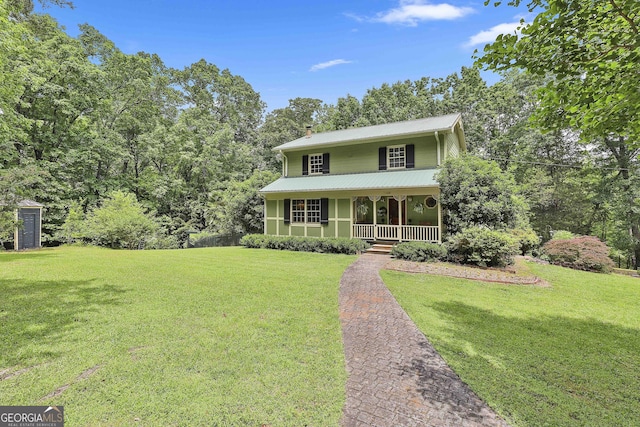 159 May Ln, Zebulon, GA 30295 - colonial home with a porch, a chimney, a front yard, and metal roof