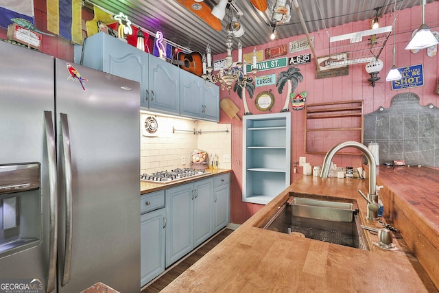 159 May Ln, Zebulon, GA 30295 - kitchen with a sink, wood counters, stainless steel appliances, decorative backsplash, and blue cabinets