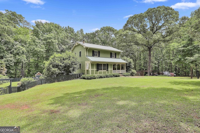 159 May Ln, Zebulon, GA 30295 - view of front of home with fence, metal roof, a sunroom, and a front lawn