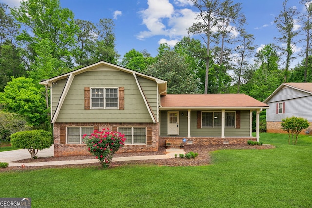 3240 Corktree Trl, Stonecrest, GA 30038 - split level home featuring brick siding, a gambrel roof, a front lawn, and a porch