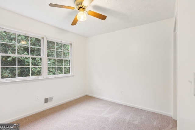 3240 Corktree Trl, Stonecrest, GA 30038 - empty room with visible vents, baseboards, ceiling fan, and light colored carpet