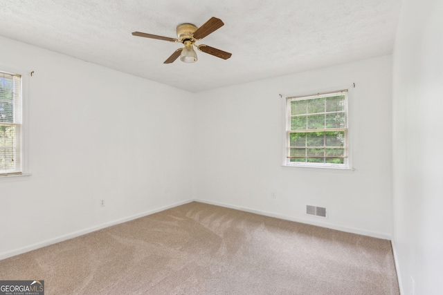 3240 Corktree Trl, Stonecrest, GA 30038 - spare room featuring carpet floors, plenty of natural light, baseboards, and visible vents
