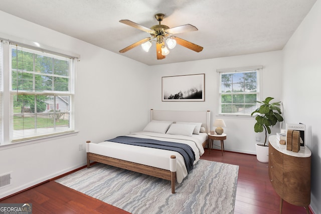 3240 Corktree Trl, Stonecrest, GA 30038 - bedroom with multiple windows, wood finished floors, and visible vents