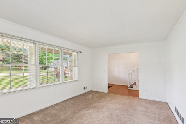 3240 Corktree Trl, Stonecrest, GA 30038 - unfurnished room featuring baseboards, visible vents, light carpet, and stairway