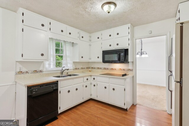 3240 Corktree Trl, Stonecrest, GA 30038 - kitchen with a sink, black appliances, light wood-style flooring, and white cabinetry