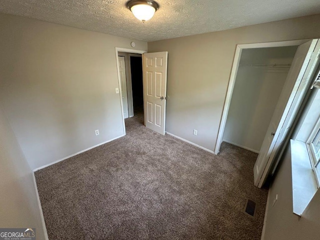 2036 Countydown Ln, Stone Mountain, GA 30088 - unfurnished bedroom with a closet, a textured ceiling, carpet, and baseboards